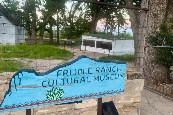 Sign for Frijole Ranch Cultural Museum in a rustic outdoor setting.