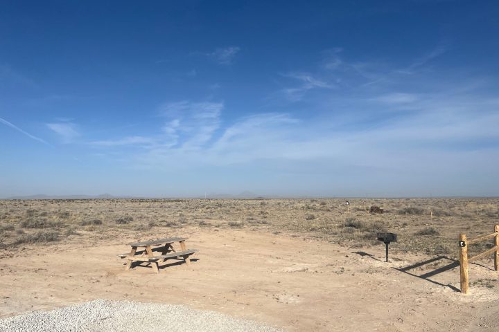 Upside-down image of a desert landscape with clear blue sky.